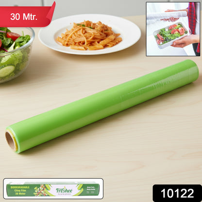 Wukusy Freshee biodegradable cling film roll, 30 meters long and 300mm wide, shown unrolled on a kitchen surface.