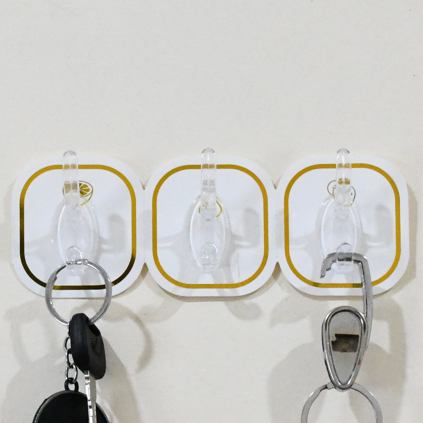 Set of six transparent adhesive wall hooks by Wukusy for home improvement, showing the clear hooks attached to a wall.