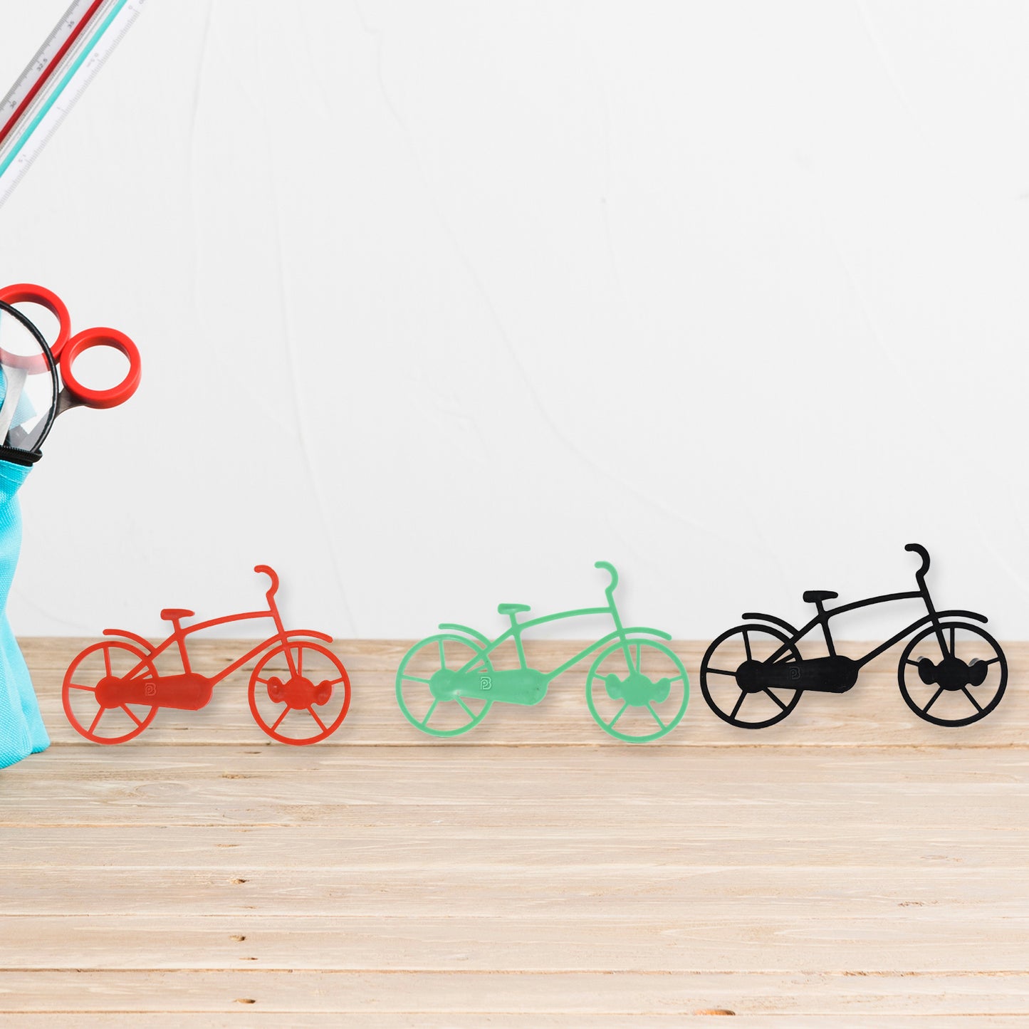Set of four Wukusy bicycle-shaped plastic key chain holders and wall mounts for home or office organization.