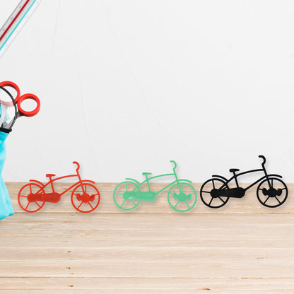 Set of four Wukusy bicycle-shaped plastic key chain holders and wall mounts for home or office organization.