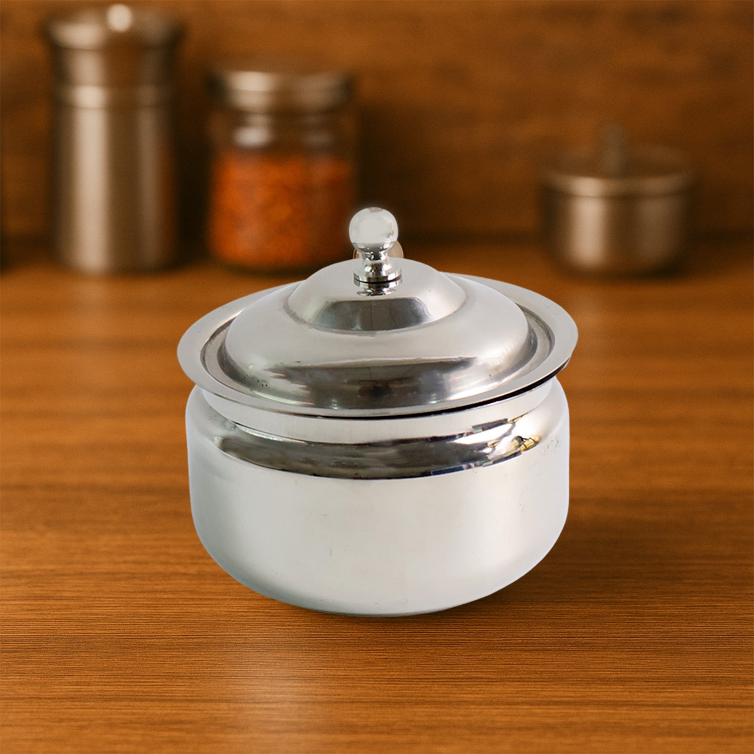 Premium stainless steel ghee pot by Wukusy, featuring a sleek lid and handle, ideal for storing and serving ghee in the kitchen.