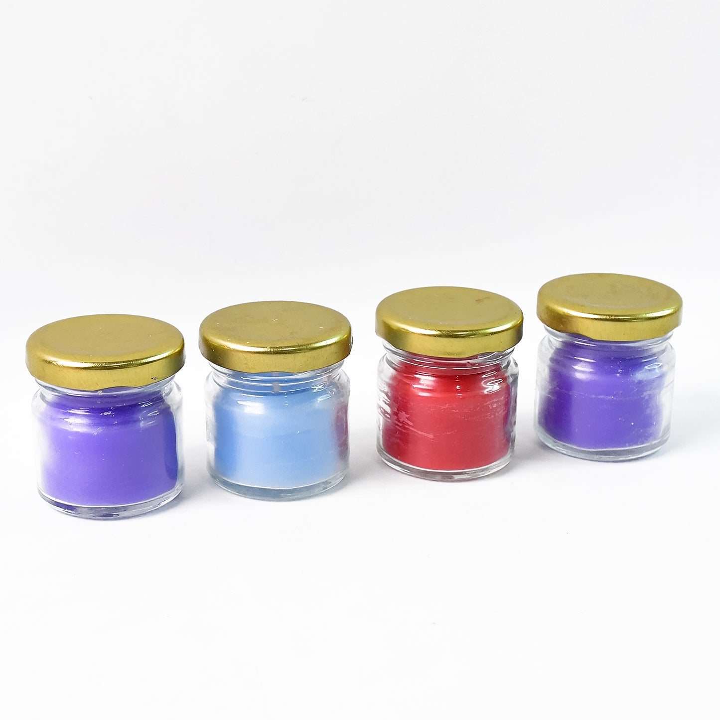 Wukusy wax candle set in glass jars with gold lids, featuring four scented candles for home decor and ambiance.