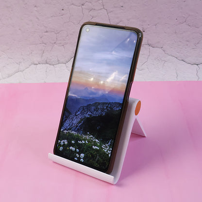 White plastic foldable desktop mobile stand by Wukusy, adjustable holder for smartphones displayed on a clean surface.