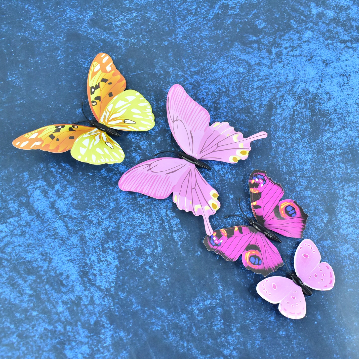 Colorful butterfly wall stickers from Wukusy, 12-piece decorative set for home decor, featuring vibrant butterfly designs on a white background.