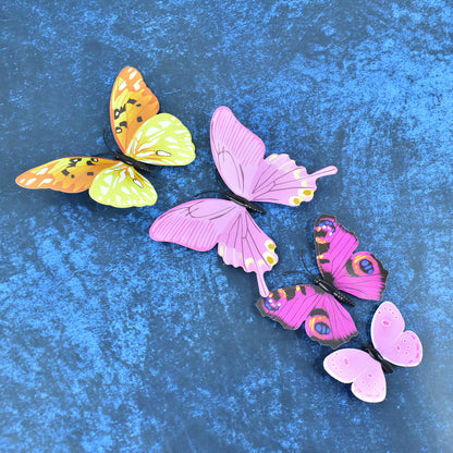 Colorful butterfly wall stickers from Wukusy, 12-piece decorative set for home decor, featuring vibrant butterfly designs on a white background.