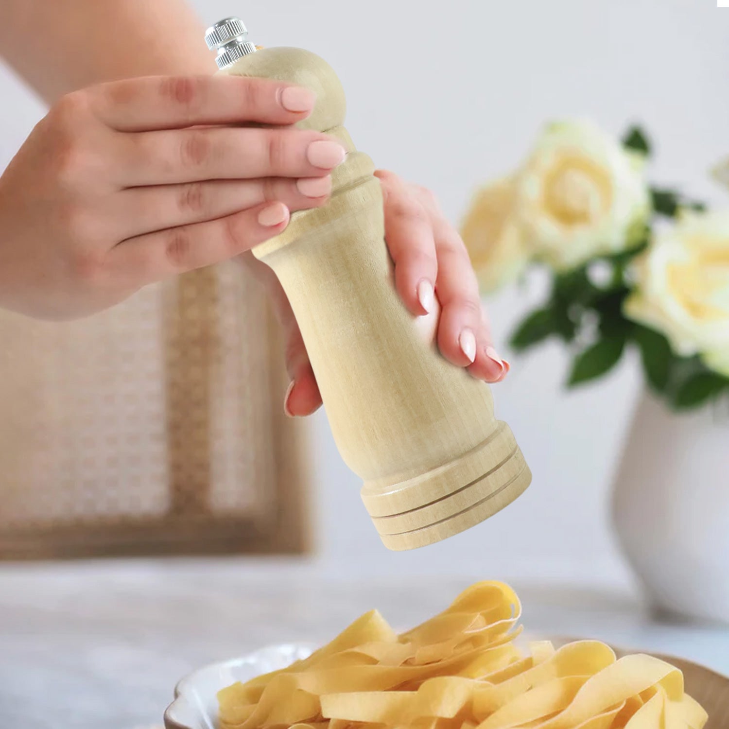 Wukusy classic wooden manual pepper grinding mill with a ceramic grinder, standing upright on a kitchen countertop.