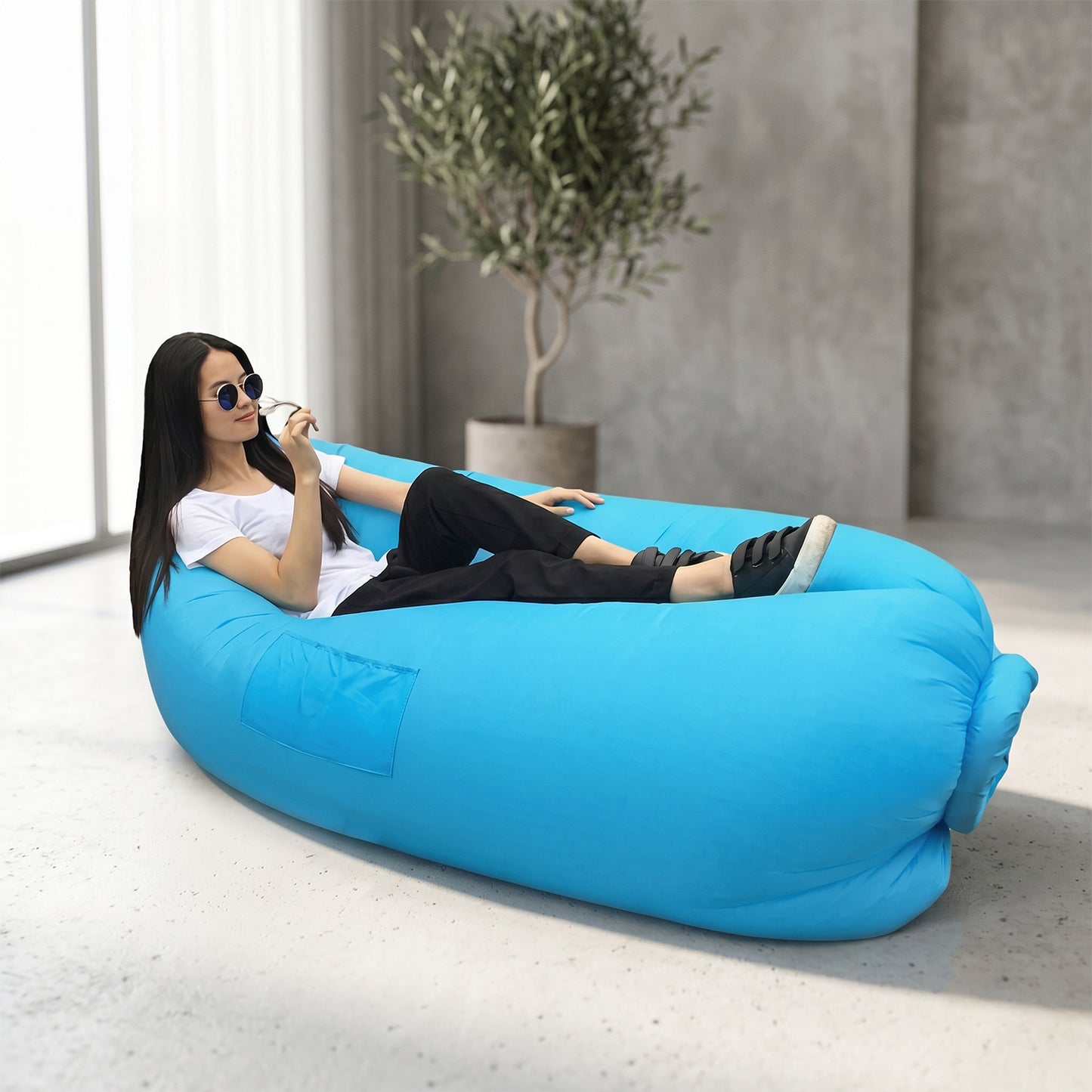 Wukusy inflatable air lounger sofa for outdoor camping, beach, and pool, shown fully inflated on a grassy area.
