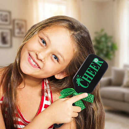 Kids printed hair brush with a cute ribbon bow handle, designed for detangling children's hair, by Wukusy.