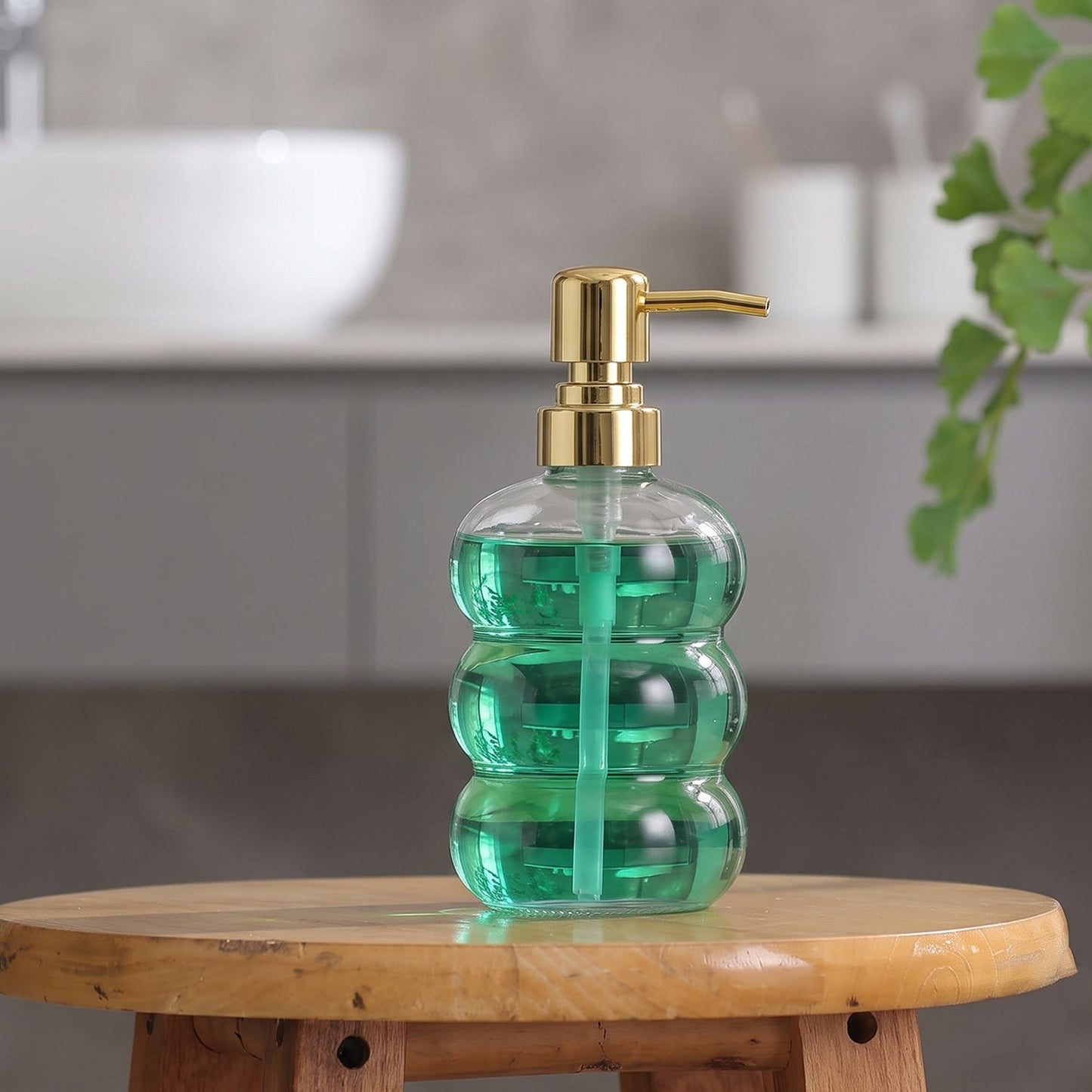 Transparent glass liquid soap dispenser bottle with gold pump by Wukusy, featuring a sleek, modern design.