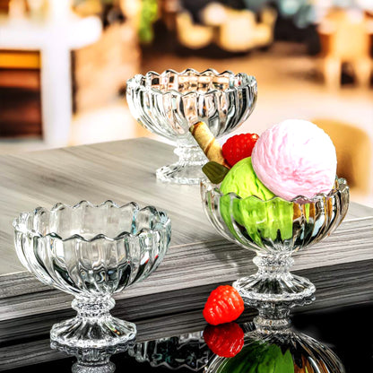 Six clear glass ice cream bowls for sundaes, featuring elegant dessert cups by Wukusy, stacked with colorful toppings.