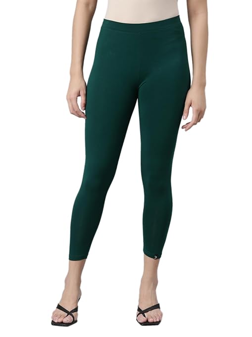 Green skinny fit high ankle length leggings by FIZZI SHOP, showing close-up of fabric texture and fitted design.