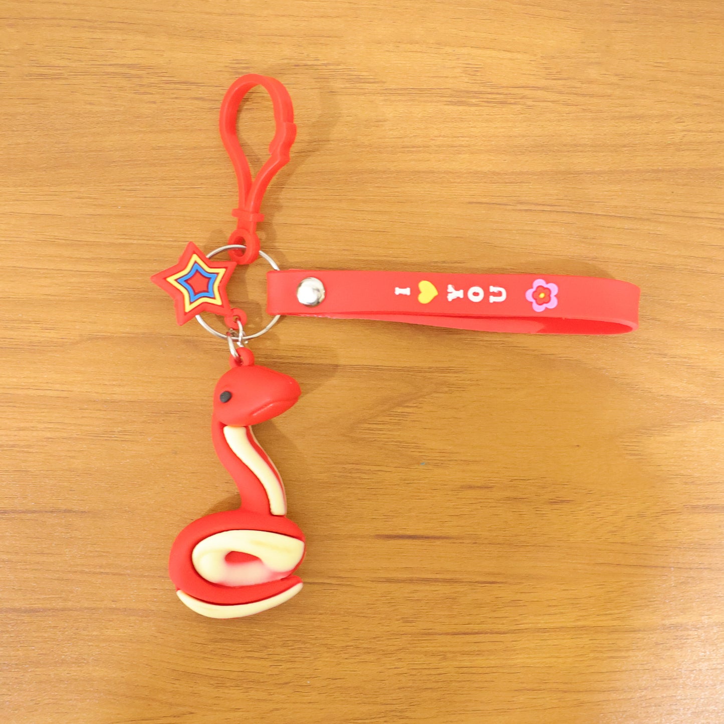 Wukusy cute snake-shaped keychain in vibrant colors, featuring a detailed snake design with a small loop for keys or accessories.