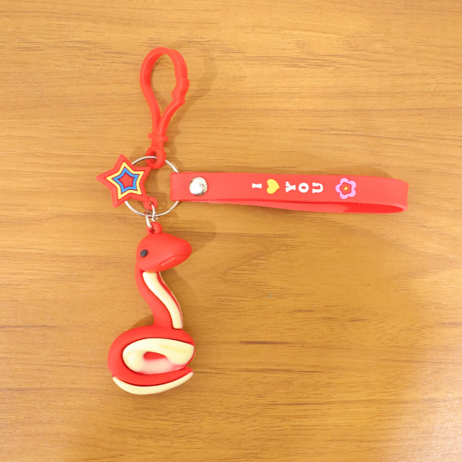 Wukusy cute snake-shaped keychain in vibrant colors, featuring a detailed snake design with a small loop for keys or accessories.