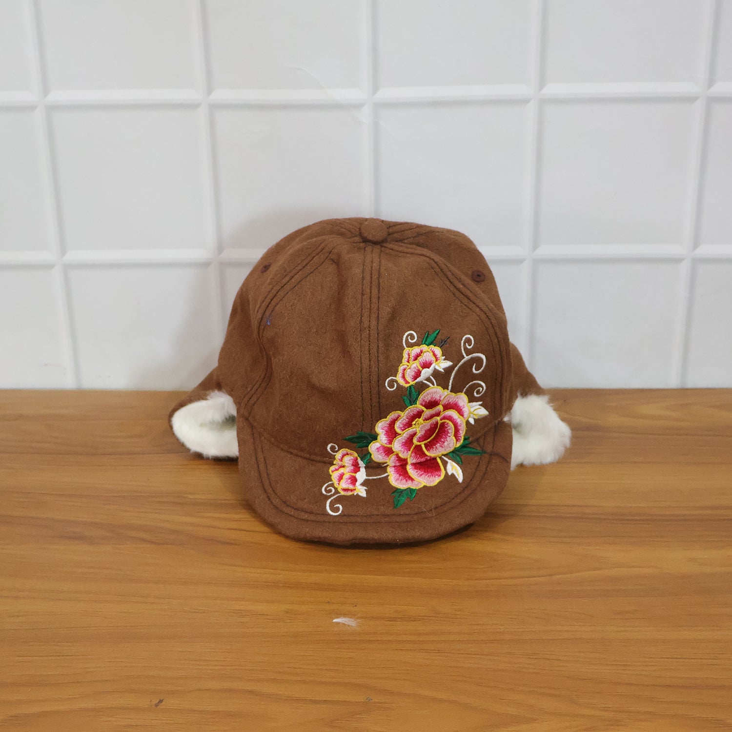 Wukusy premium winter ear flap cap for women, featuring warm ear flaps and cozy knit design for cold weather protection.