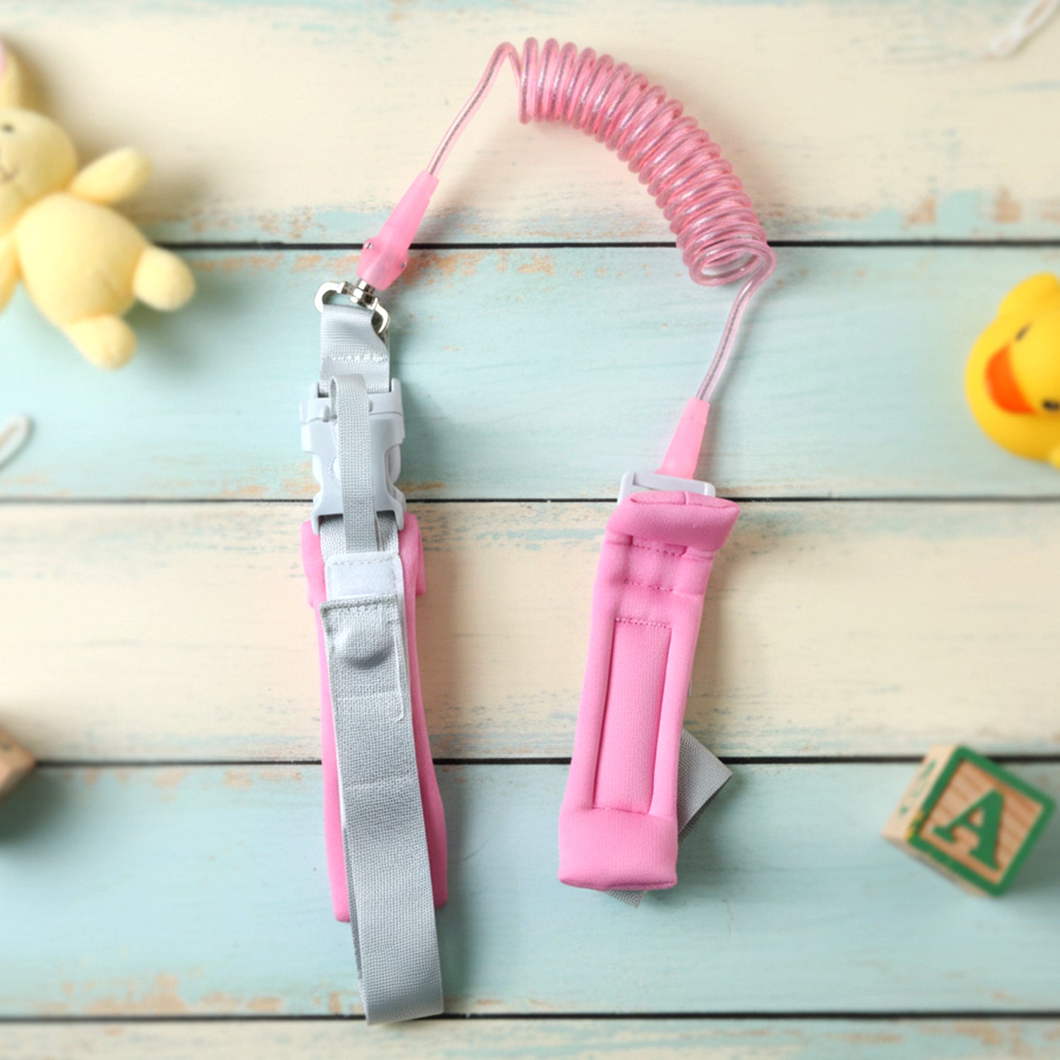 Wukusy Mix Design Baby Safety Walking Leash attached to a child's hand, preventing child from wandering during outdoor walks.