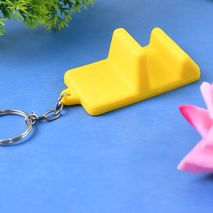 Wukusy plastic 2-in-1 mobile stand keychain attached to a smartphone for hands-free viewing and portability.