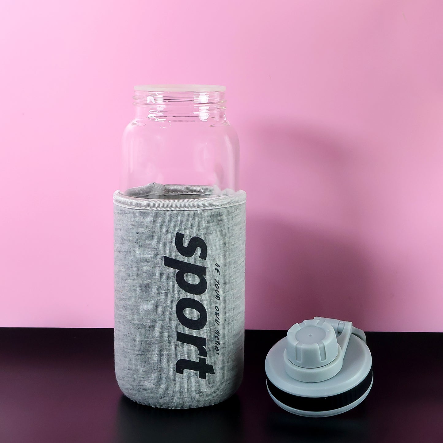 Wukusy 700ml sports water bottle with protective sleeve, featuring a clear design and leak-proof lid for active hydration.