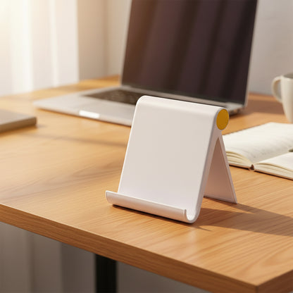 White plastic foldable desktop mobile stand from Wukusy, designed to hold smartphones securely on a flat surface.