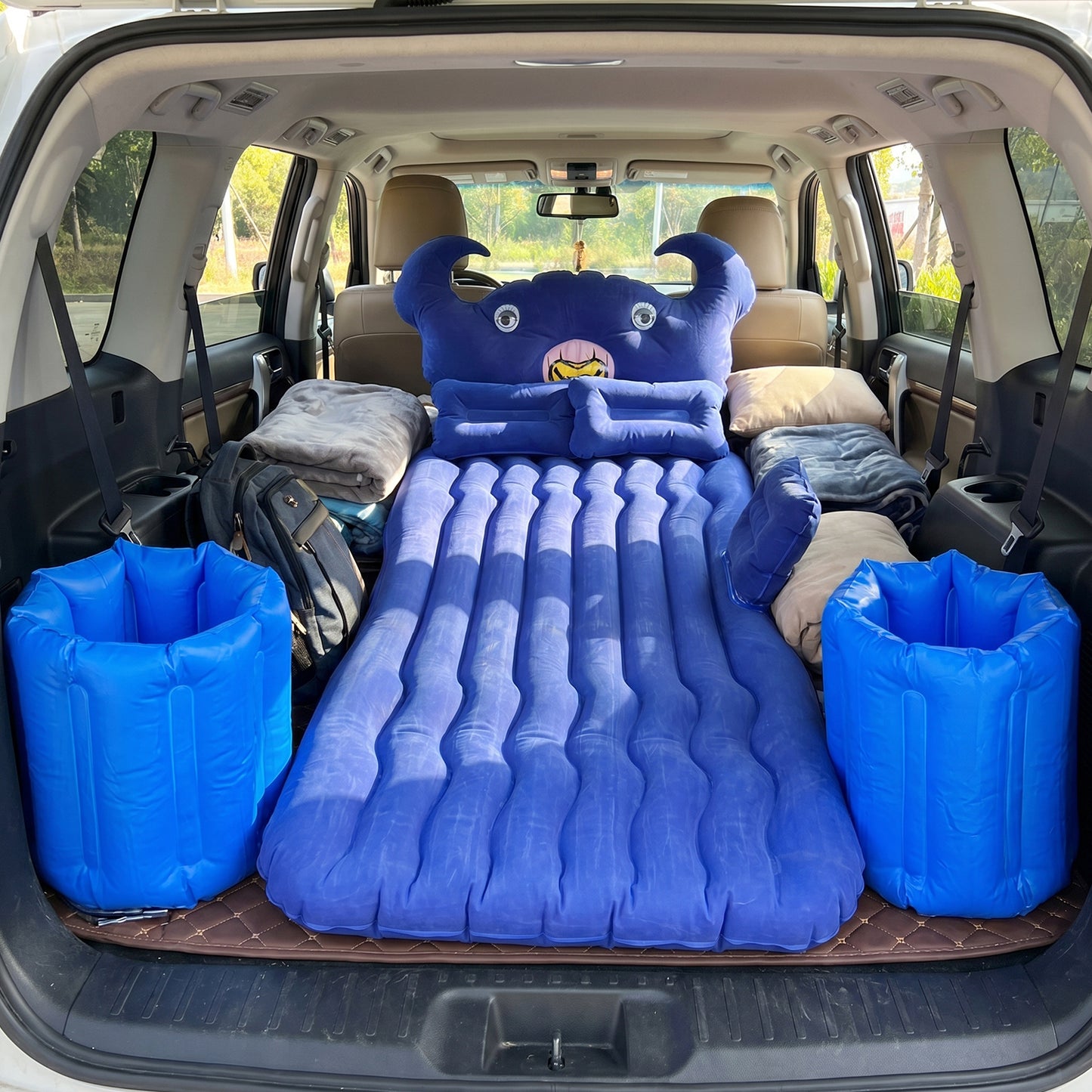 Wukusy car air mattress bed set with inflatable cushions and pump, shown with the mattress inflated and accessories inside the car.