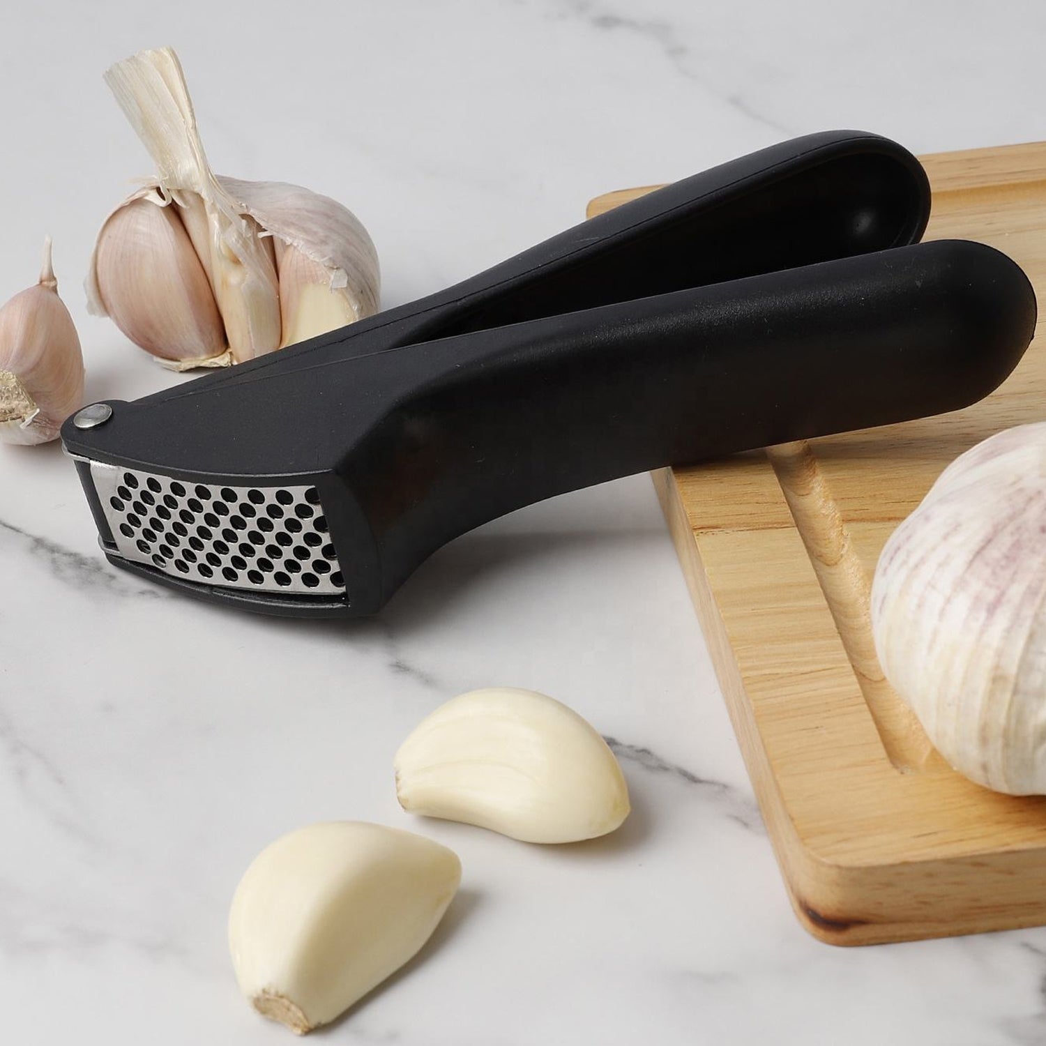 Wukusy manual garlic press crusher tool with stainless steel handles and chamber for effortless garlic crushing.