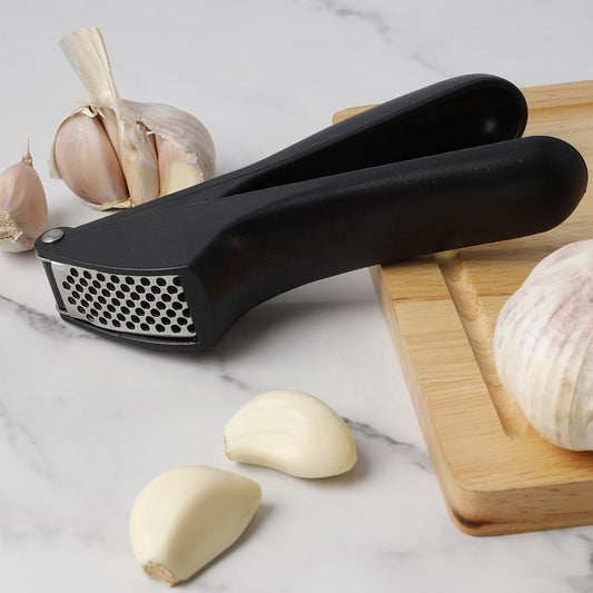 Wukusy manual garlic press crusher tool with stainless steel handles and chamber for effortless garlic crushing.