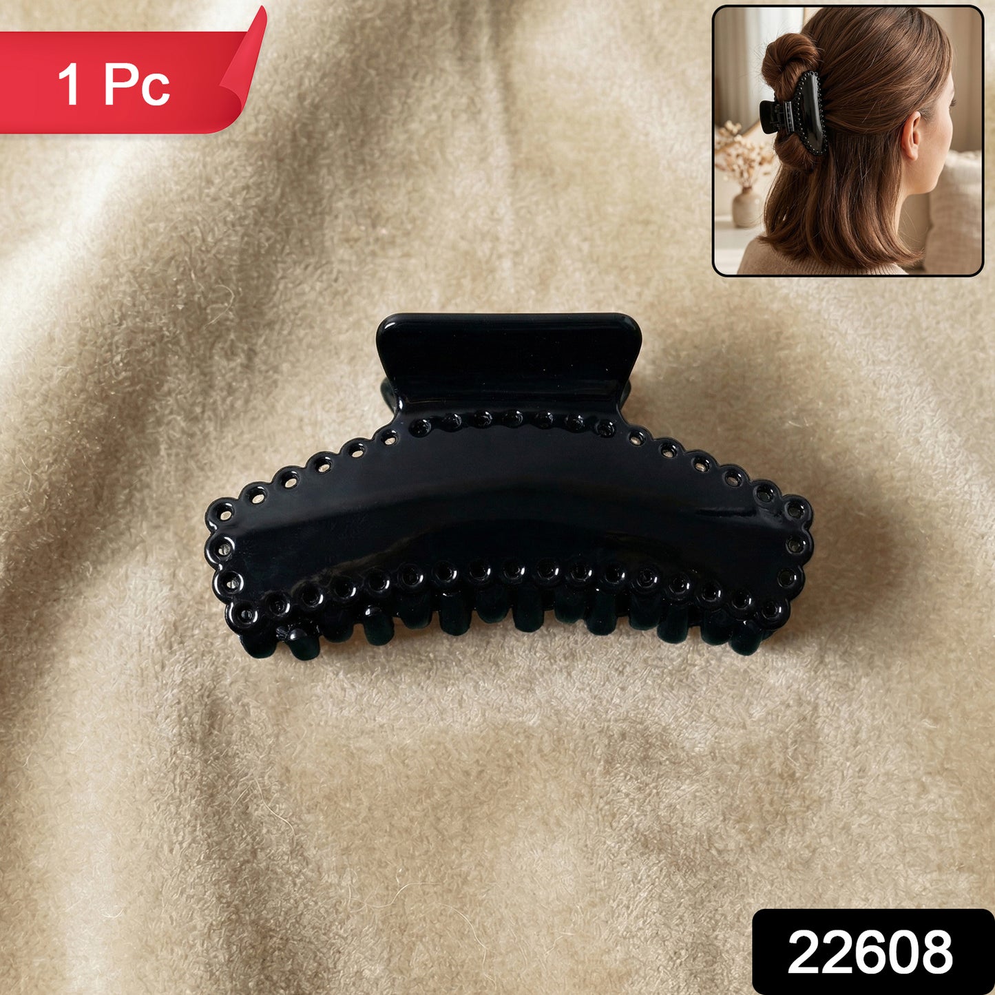 Black Wukusy hair claw clip, elegant and sturdy, shown holding a section of hair in a natural style.