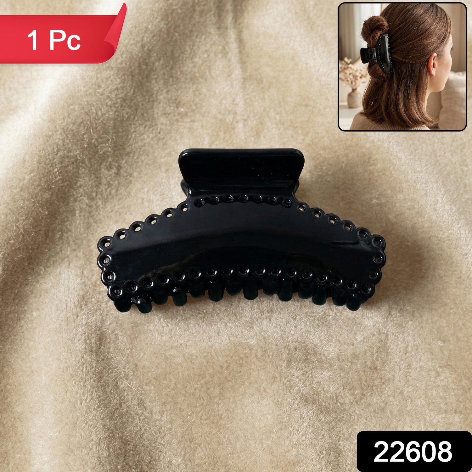 Black Wukusy hair claw clip, elegant and sturdy, shown holding a section of hair in a natural style.