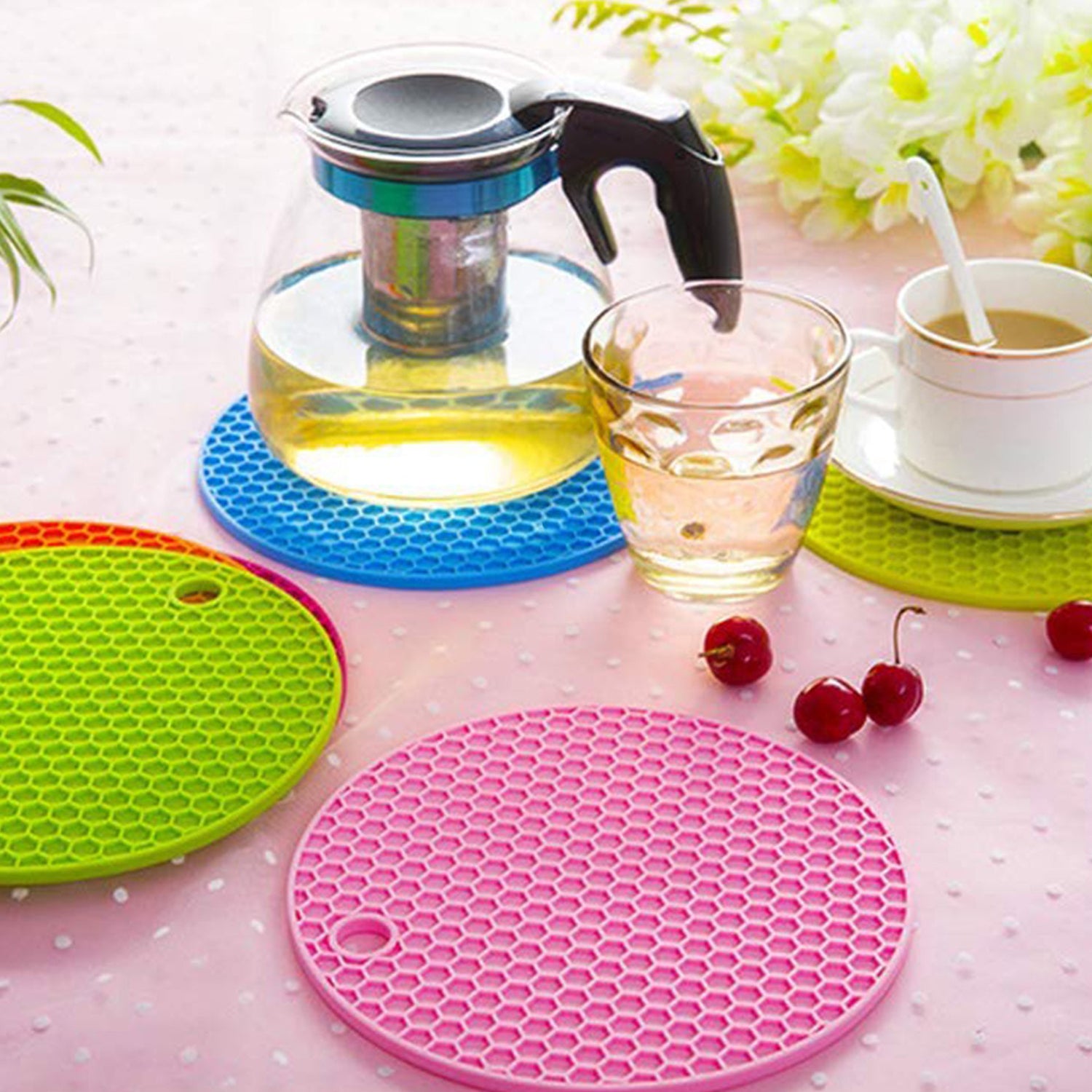 Wukusy 4-piece silicone hot mat set with black heat-resistant mats for placing hot vessels and utensils safely without surface marks