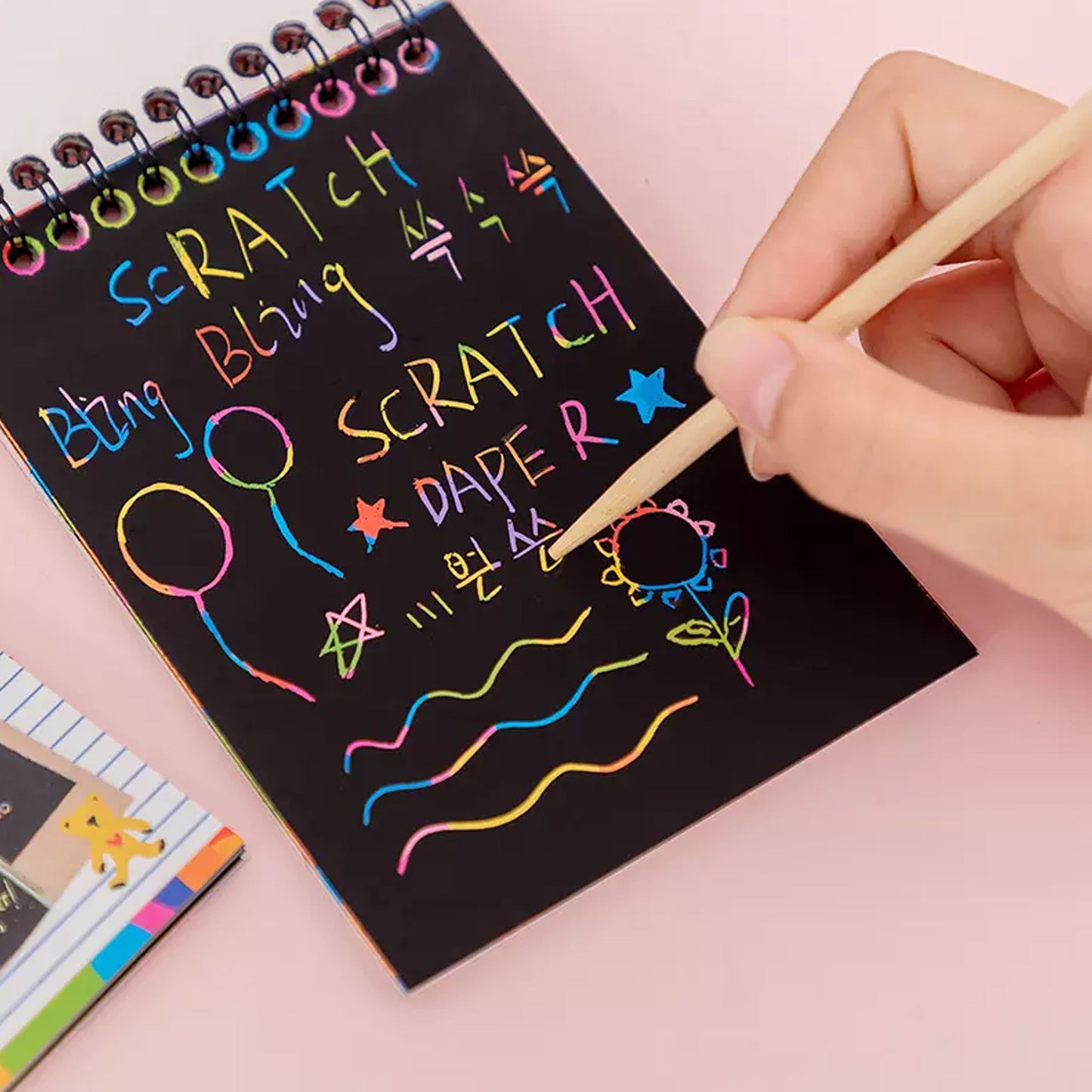Wukusy Crafts Rainbow Art Scratch Paper Book with 10 colorful pages for kids' creative art projects and activities.
