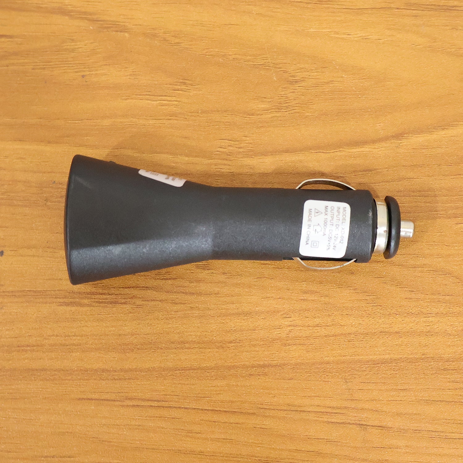 Wukusy 12V single USB car charger adapter for mobile devices, plugged into a vehicle's cigarette lighter socket.