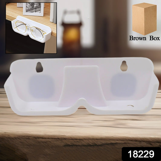 Wukusy wall mount adhesive sunglass holder attached to a wall, designed to securely hold multiple pairs of sunglasses in a home.