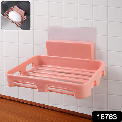 Wukusy self-adhesive rectangular soap dish holder attached to a bathroom wall, designed for easy soap storage and drainage.