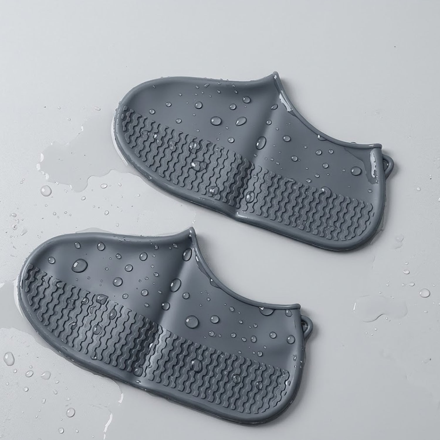 Pair of Wukusy waterproof silicone shoe covers in grey, medium size, designed to protect shoes from water and dirt.
