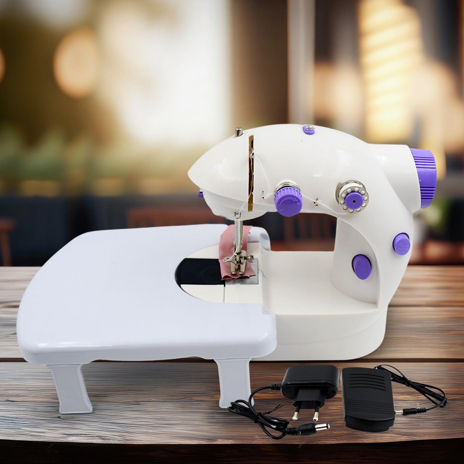 Wukusy home tailoring sewing machine with extension table, foot pedal, and portable electric mini stitching machine in a workspace.