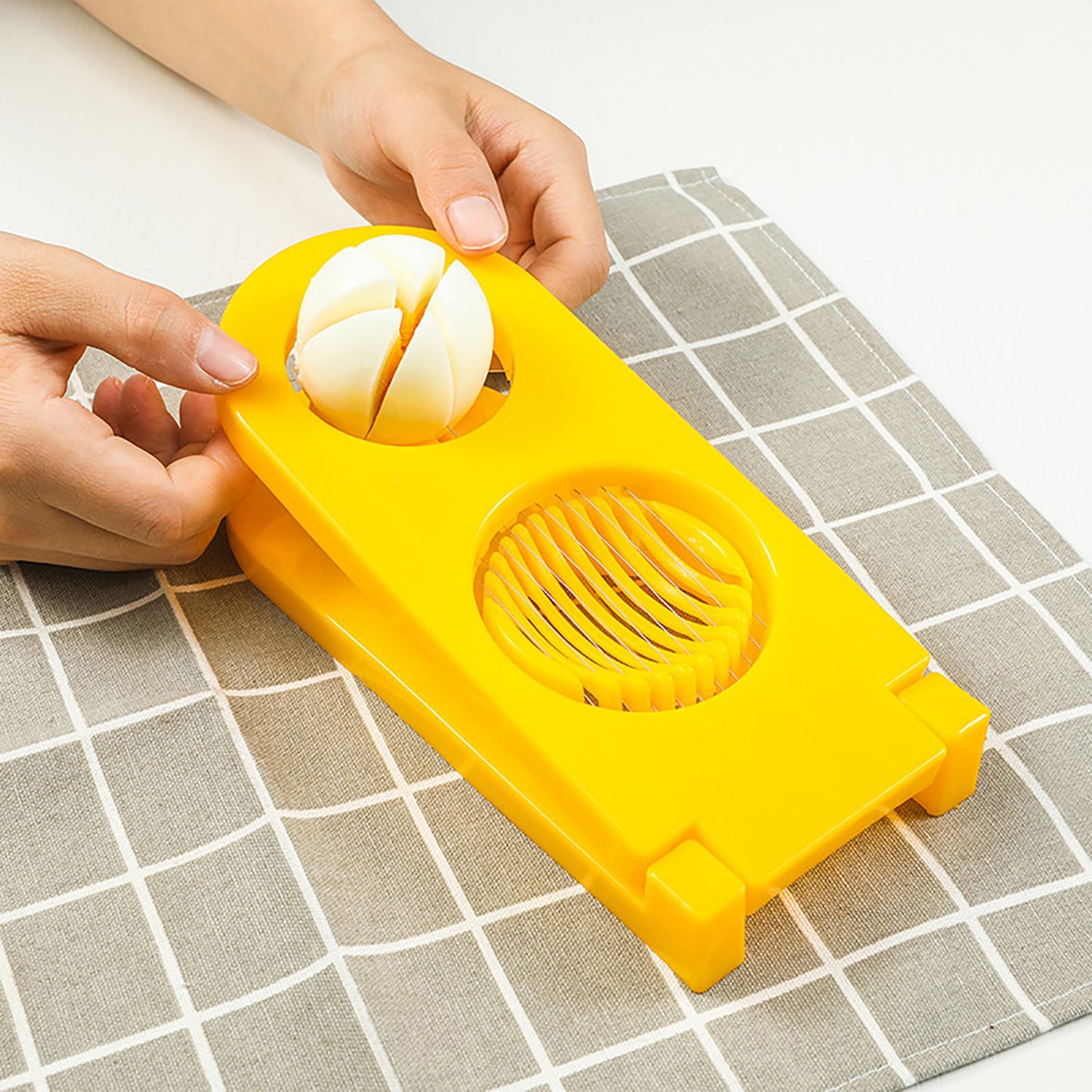Wukusy 2006 2-in-1 double cut boiled egg cutter with stainless steel wire for easy slicing of boiled eggs in kitchen.