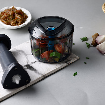 Wukusy Ganesh Bingo Lock-unlock Push Chopper in 725ml with Ganesh design, featuring a clear container and lid for easy chopping.