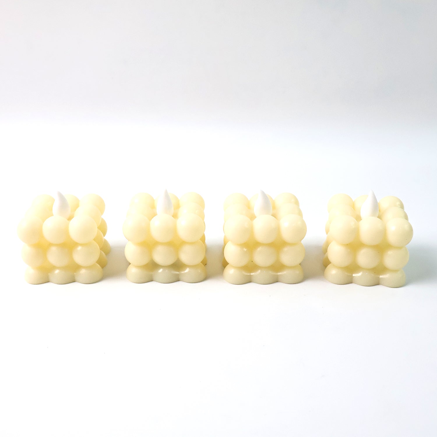 Set of four decorative LED bubble candles by Wukusy, designed for home decor with glowing, bubble-like features.