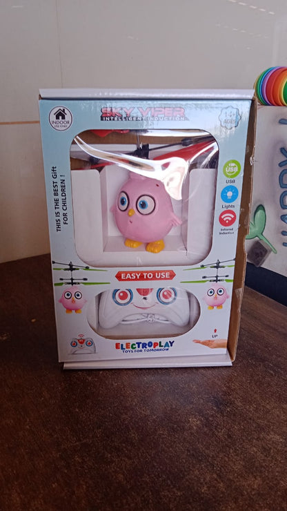 Pink owl RC toy with LED lights, remote control, flying bird design by Wukusy, perfect for kids' play and entertainment.