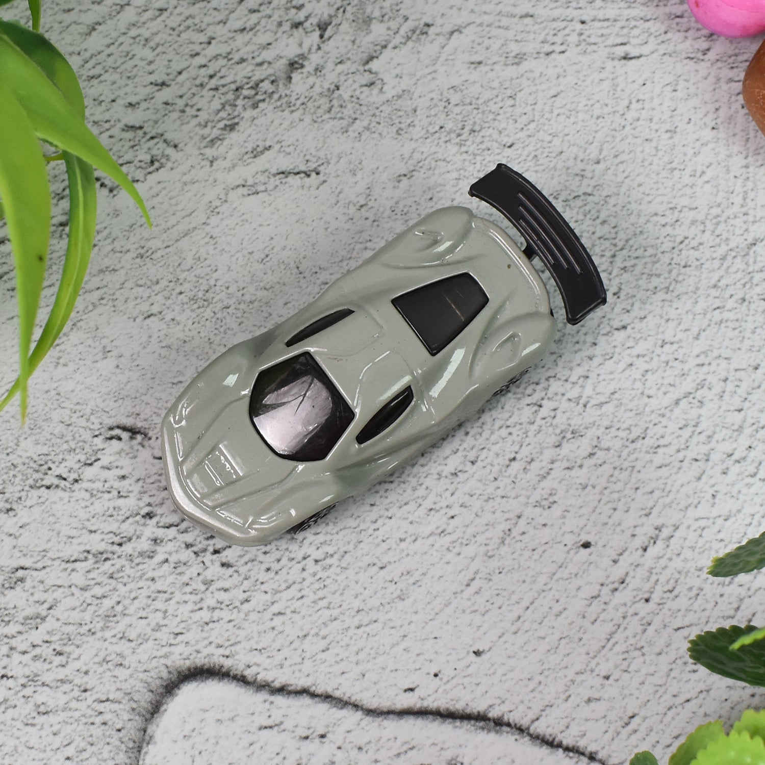Colorful metal mini car toy by Wukusy with free wheel design, perfect for children, showcasing a multicolor toy vehicle.