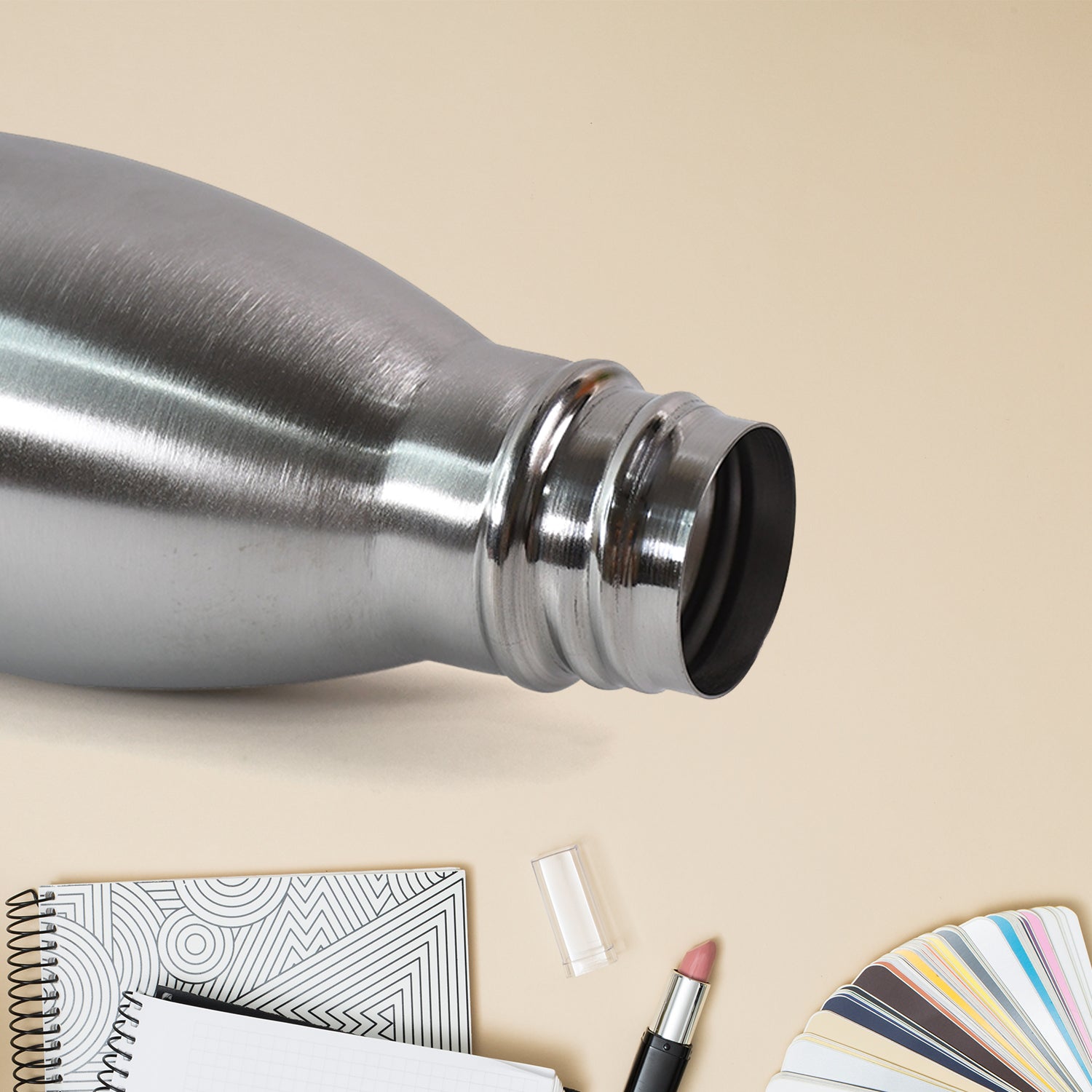 Silver stainless steel water bottle by Wukusy, 500 ml capacity, with a sleek, cylindrical design and screw-top lid.