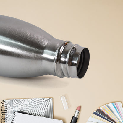 Silver stainless steel water bottle by Wukusy, 500 ml capacity, with a sleek, cylindrical design and screw-top lid.