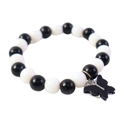 Elegant black and white fancy bracelet by Wukusy featuring intricate design and stylish accents on a neutral background.