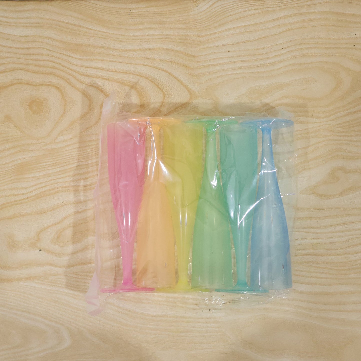 Set of six reusable plastic champagne flutes in assorted colors by Wukusy, featuring clear, lightweight wine glasses for celebrations.