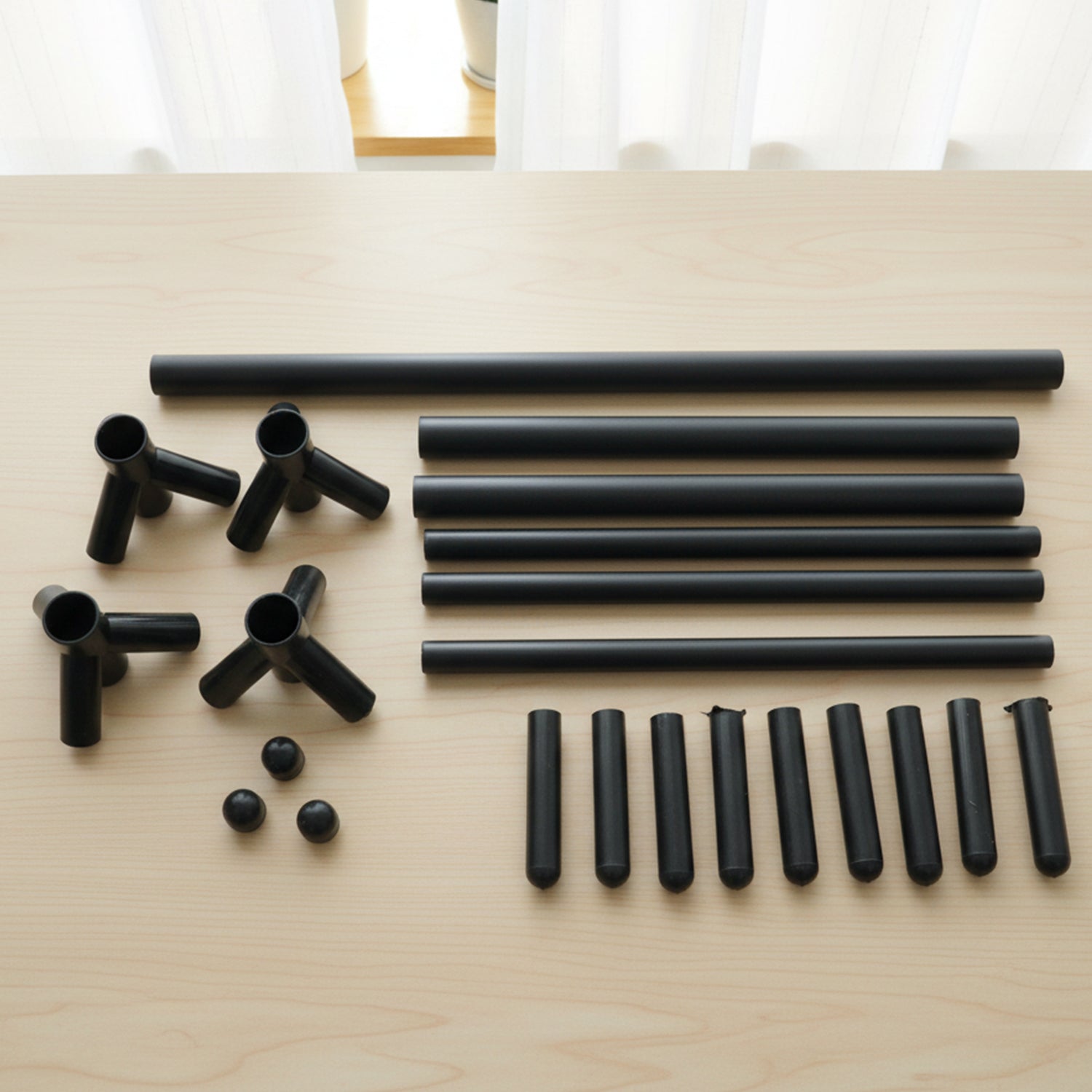 Wukusy floor-standing metal coat rack with multiple hooks for hanging coats, hats, and accessories in an entryway or hallway.