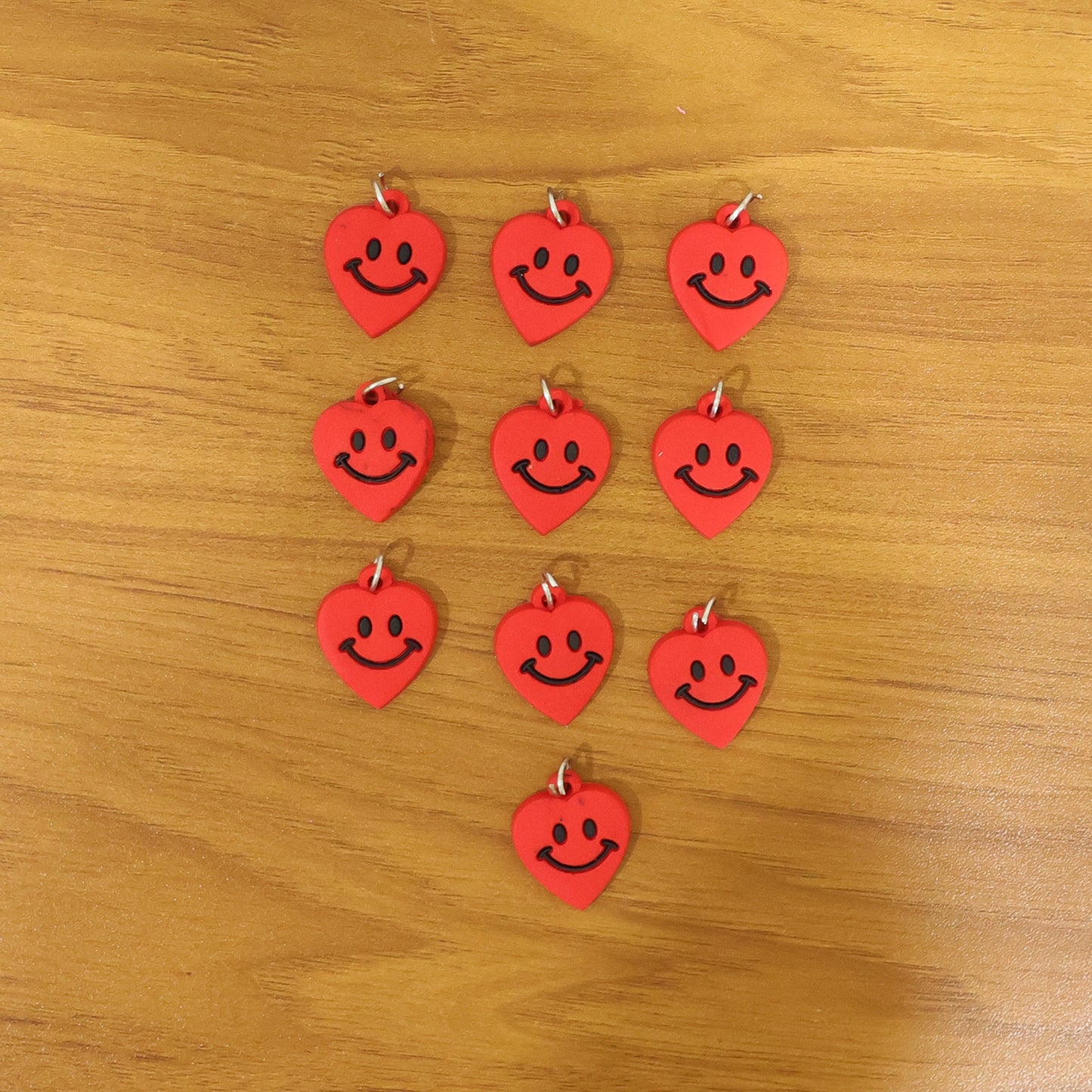 Set of 10 Wukusy cute smiley heart-shaped bag charm keychains in vibrant colors, perfect for decorating bags and keys.