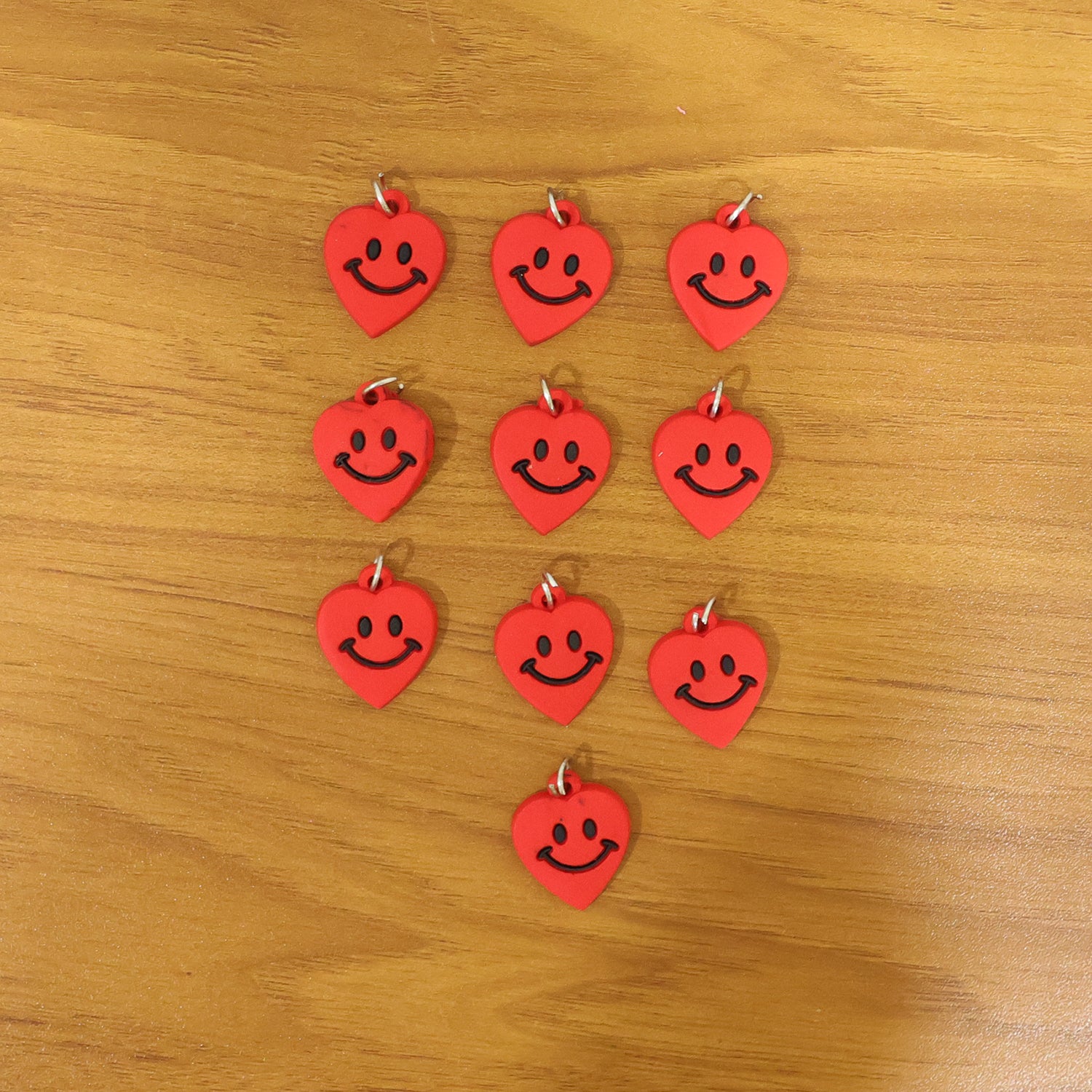 Set of 10 Wukusy cute smiley heart-shaped bag charm keychains in vibrant colors, perfect for decorating bags and keys.
