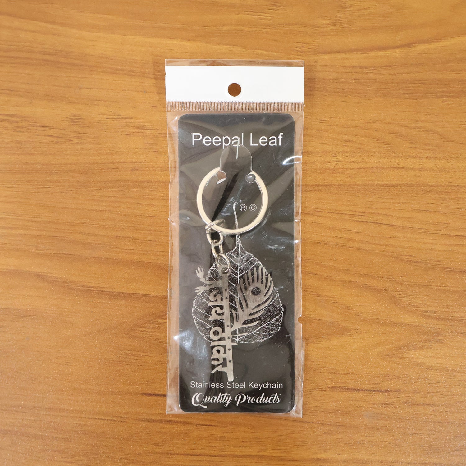 Silver metal Jay Thakar Peepal leaf keychain with intricate design, featuring the Wukusy brand logo.