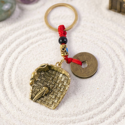 Copper plated dustpan pendant keychain with lucky coin bag charm, Feng Shui design, by Wukusy, for good fortune and style.