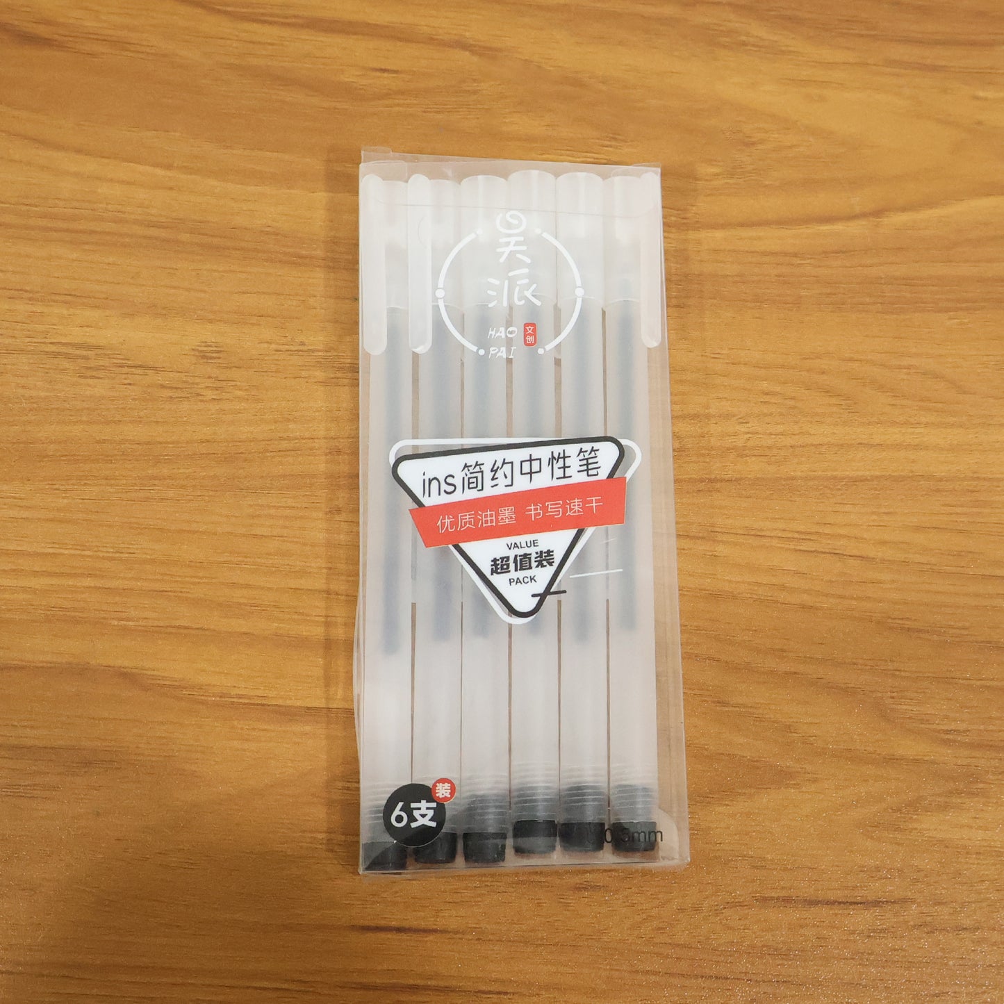 Set of six transparent black gel pens by Wukusy featuring smooth writing tips and clear barrels showing ink levels.