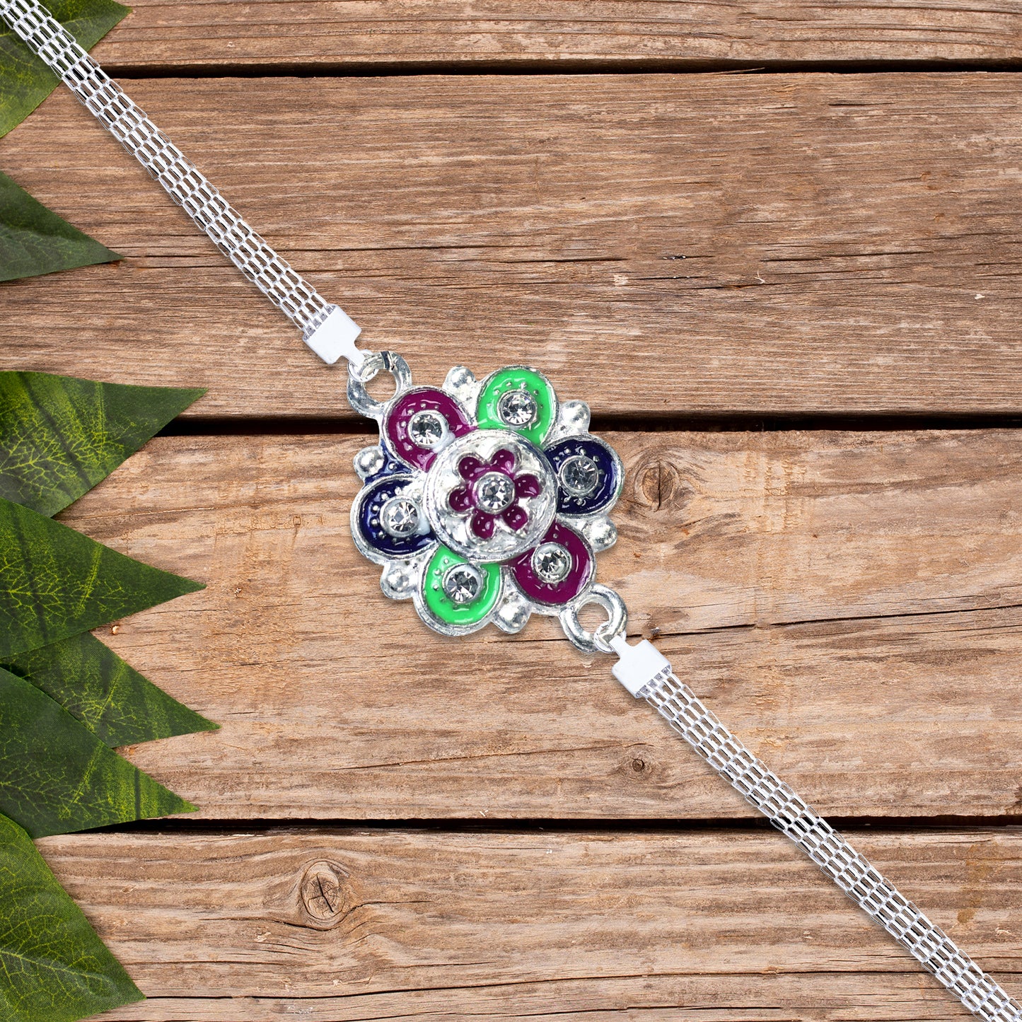 Silver flower motif Rakhi from Wukusy featuring intricate floral design and traditional craftsmanship for festive celebrations.